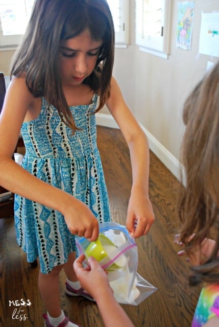 child pouring sugar into a large ziploc bag