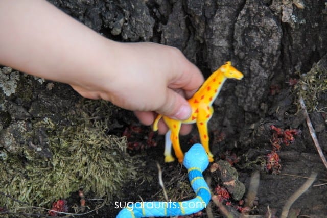 child's hand with toy giraffe