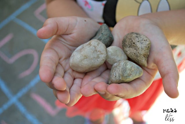 child holding rocks