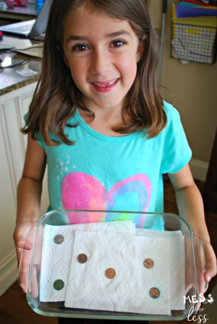 child with green pennies