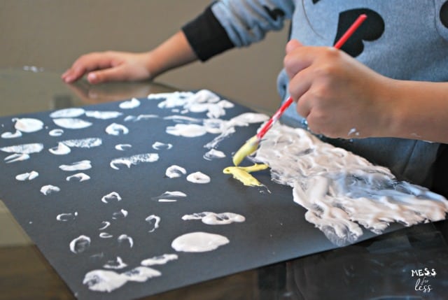 child using shaving cream paint