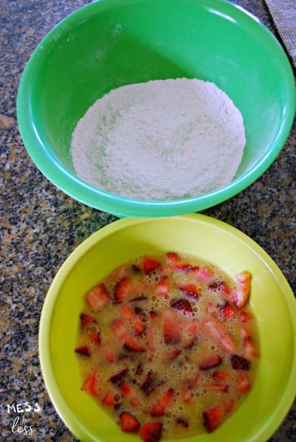 strawberries in a bowl and flowers in a bowl