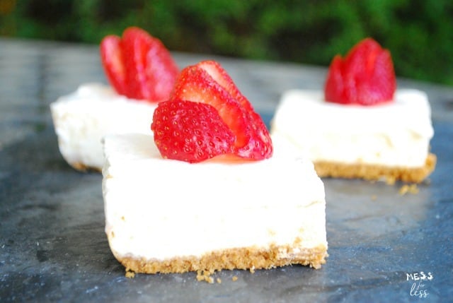 cheesecake bars with strawberries on top