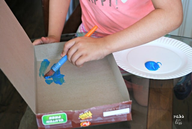 child painting cereal box