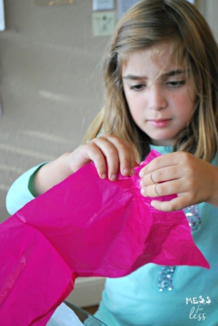 child tearing tissue paper