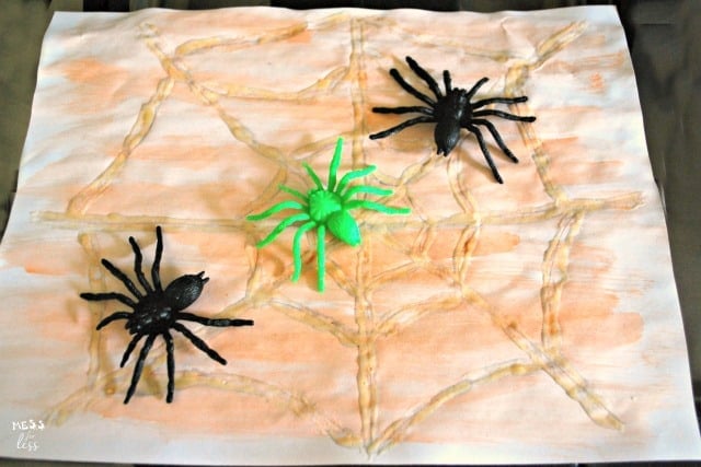 watercolor spider webs with toy spiders