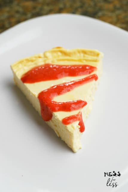 slice of one point cheesecake with strawberry drizzle