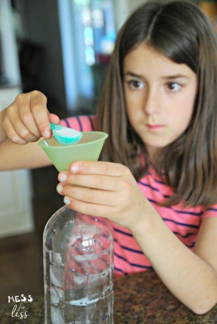 child pouring baking soda into a bottle