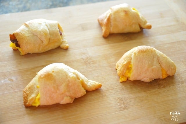 Bacon Egg and Cheese Crescents on a wooden cutting board