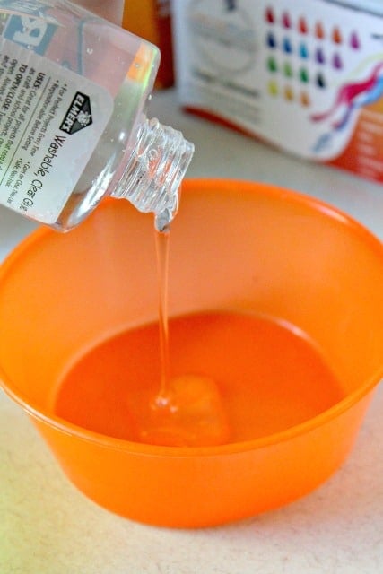 pouring glue into a bowl to make slime