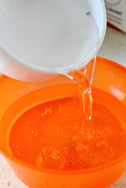 adding water to a bowl when making slime