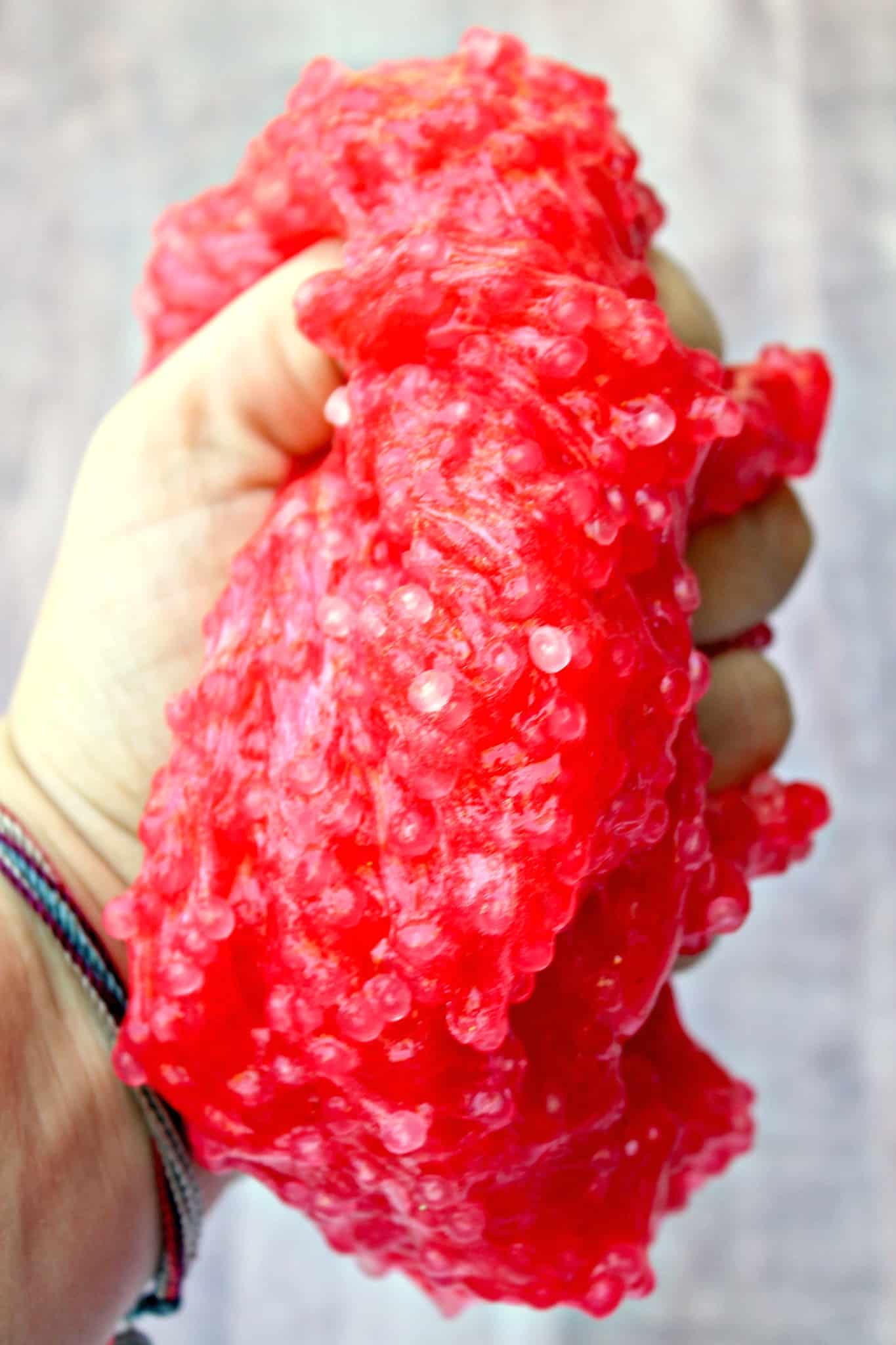 hand squeezing slushie slime