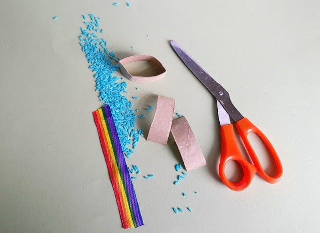 colored rice, rainbow ribbon and scissors