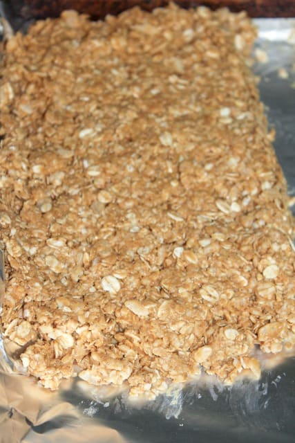 placing no bake granola bars in a pan