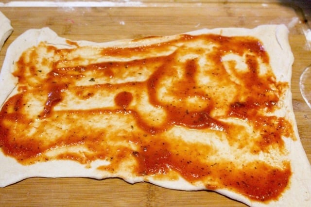 pizza sauce spread on dough