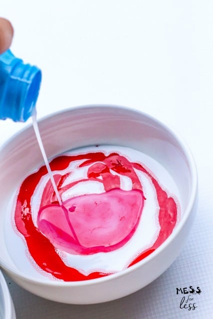 pour liquid starch into a bowl of glue and red paint