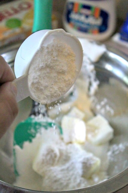 pouring powdered sugar into a bowl