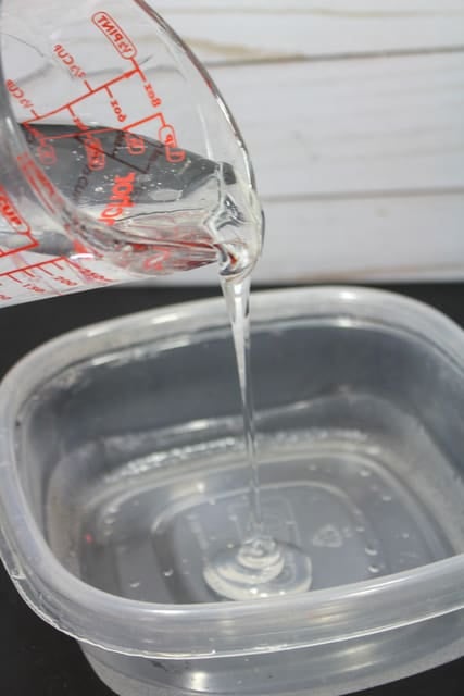 pouring clear glue in a bowl