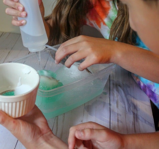 kids playing with frozen dinosaur eggs