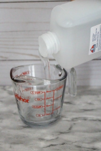 pour clear glue into a measuring cup