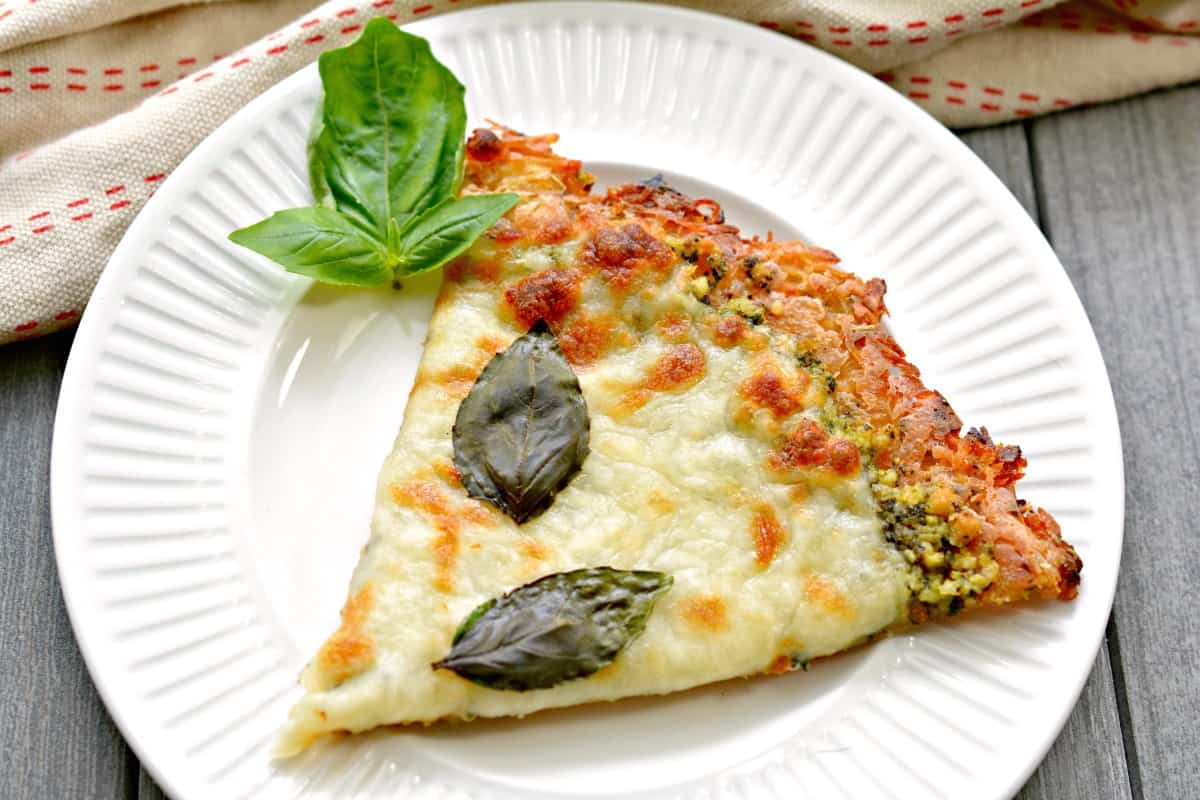 slice of Keto Pizza with Chicken Crust and Pesto