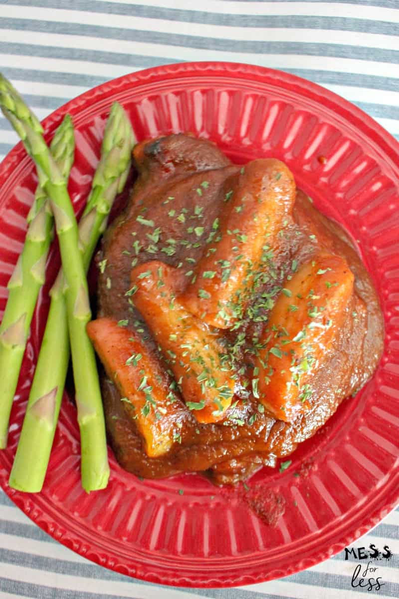 apple butter pork chops with asparagus on plate