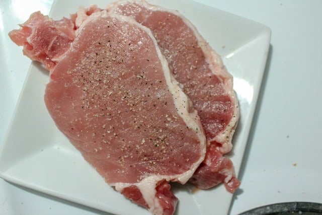 raw pork chops with salt and pepper