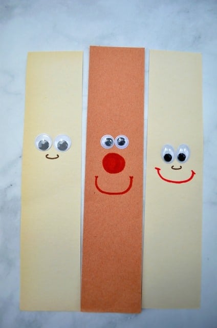 three strips of paper with googly eyes