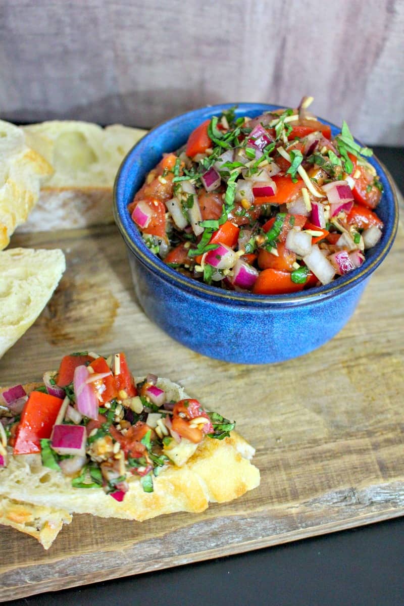 bruschetta in a blue bowl with bread
