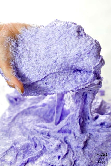 purple cloud slime being held by a hand