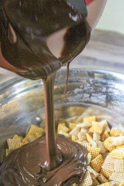 pouring chocolate on chex mix