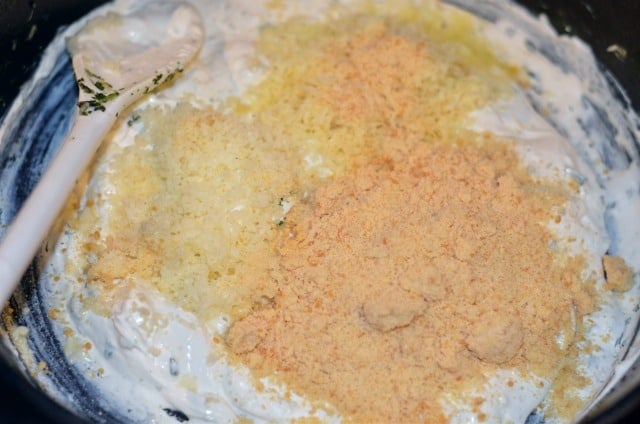 making spinach artichoke dip in a skillet