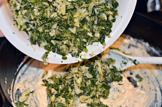 adding spinach to dip