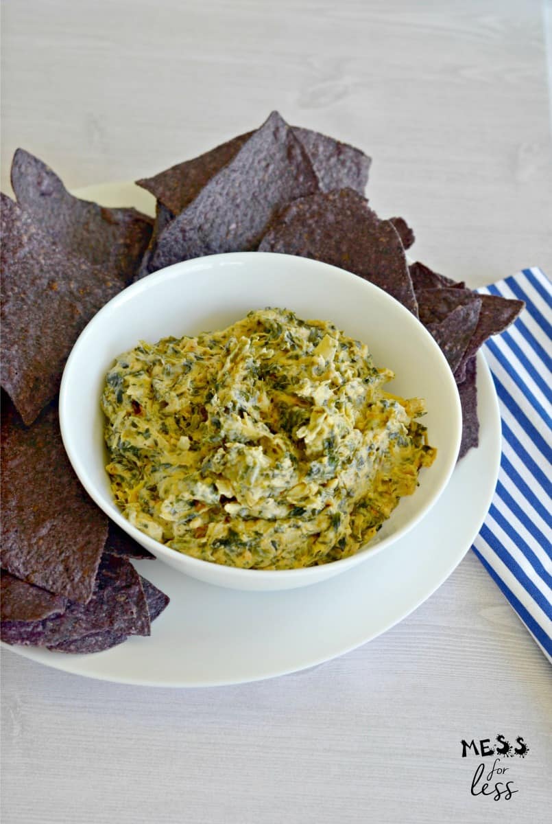 spinach artichoke dip in bowl with chips