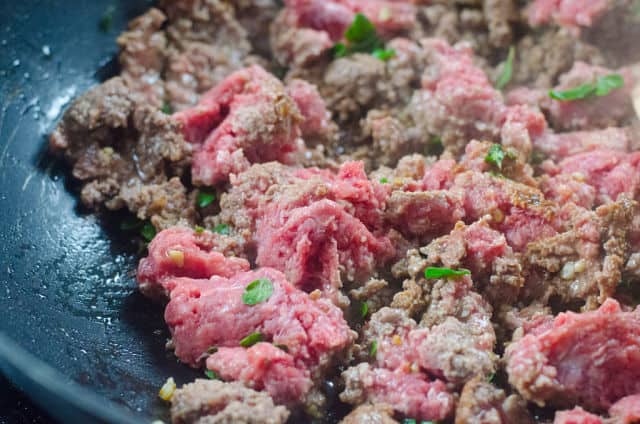 ground beef cooking in a pan