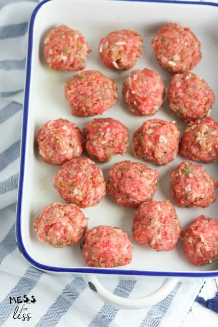 uncooked Mozzarella Stuffed Meatballs in pan