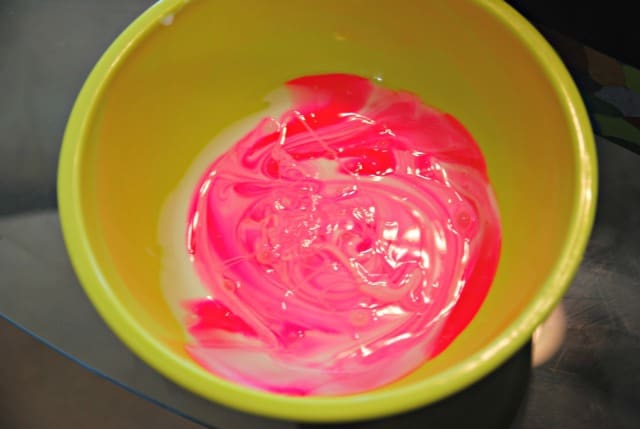 mixing paint and glue in a bowl