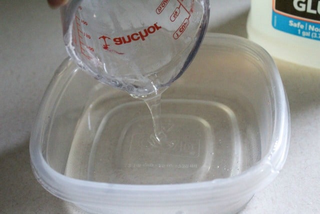 pouring clear glue into a bowl