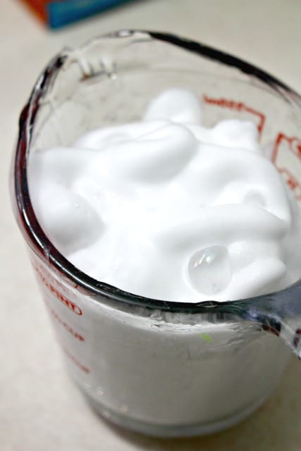 shaving cream in a measuring cup