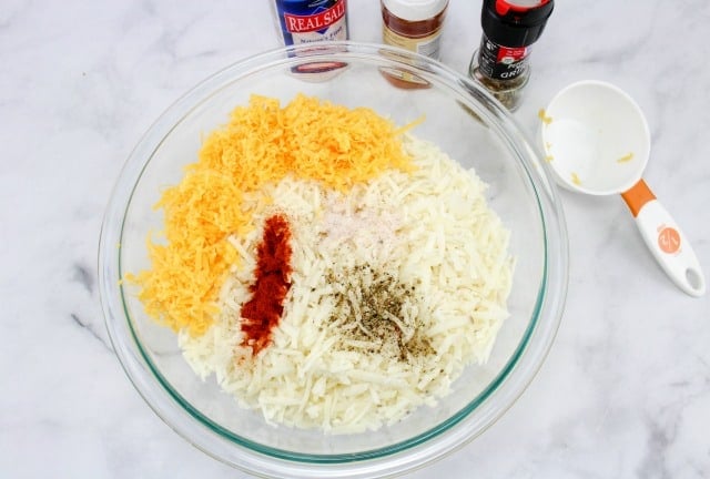 hash browns and cheese in a glass bowl