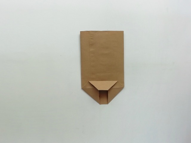 folding a brown paper bag