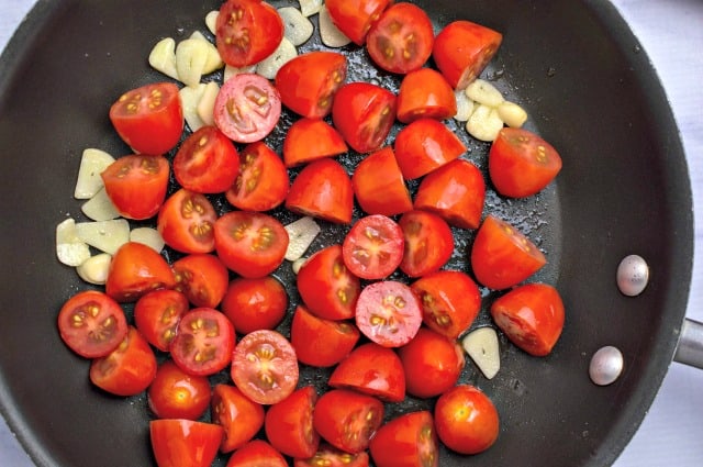 grape tomatoes and garlic in pan