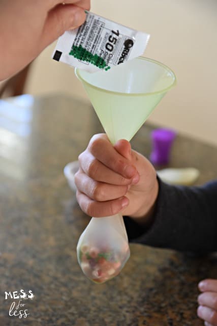 adding water beads to a balloon