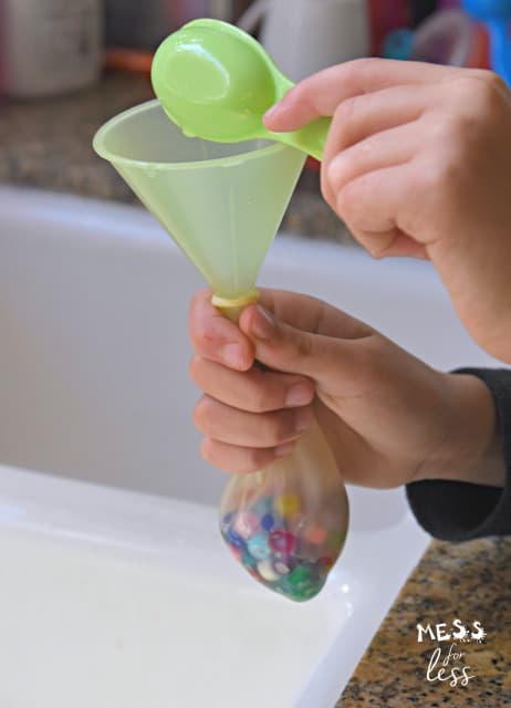 pouring water into a balloon