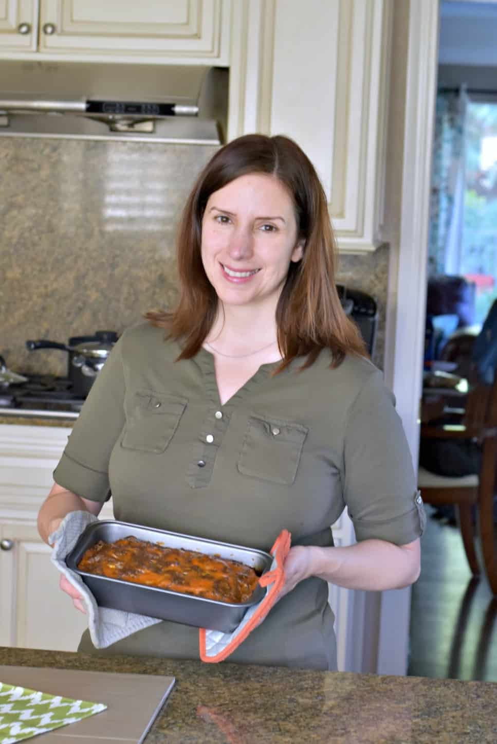 woman holding meatloaf in a pan