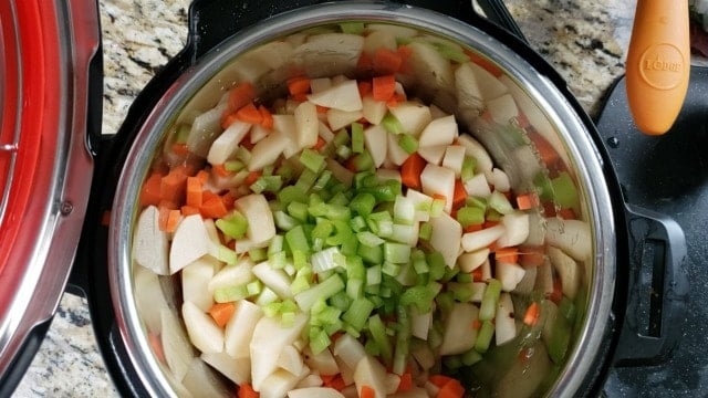 instant pot filled with potatoes carrots and celery