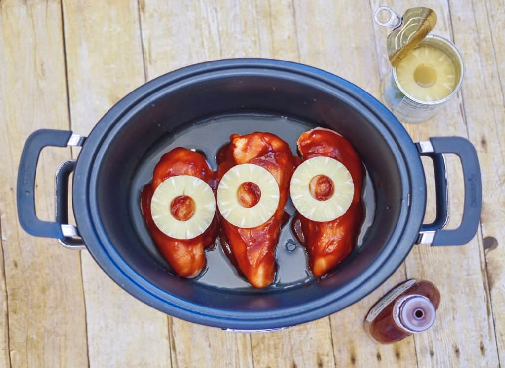 chicken in a slow cooker with bbq sauce and pineapple