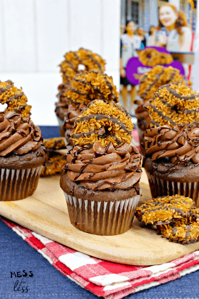 cupcakes topped with chocolate frosting and samoa cookies