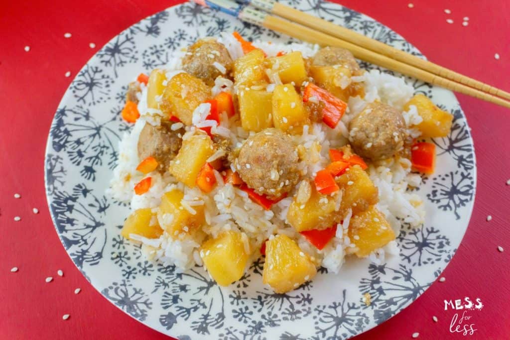 meatballs with rice and pineapple on plate with chopsticks