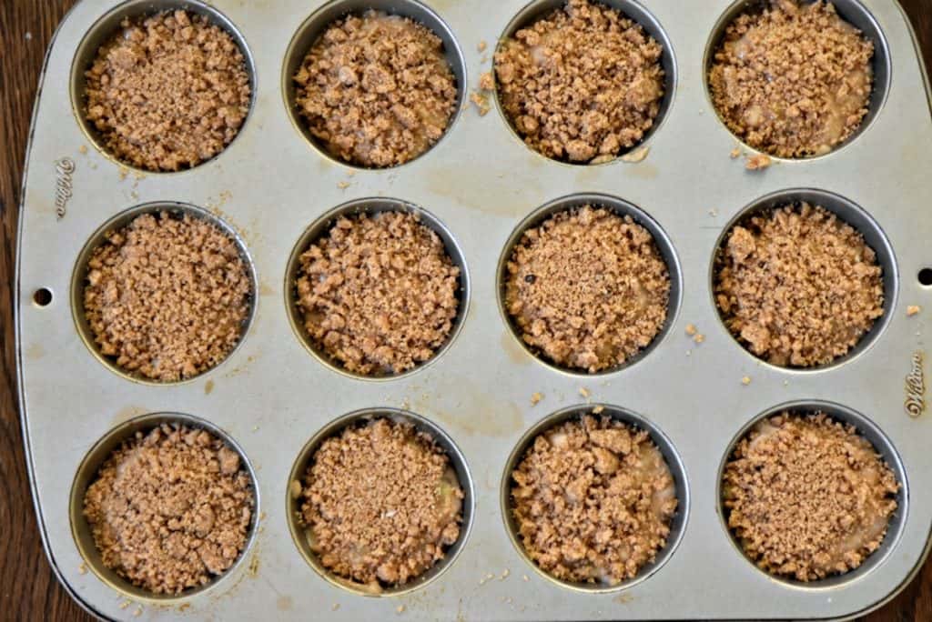 muffin batter with crumb topping in muffin pan